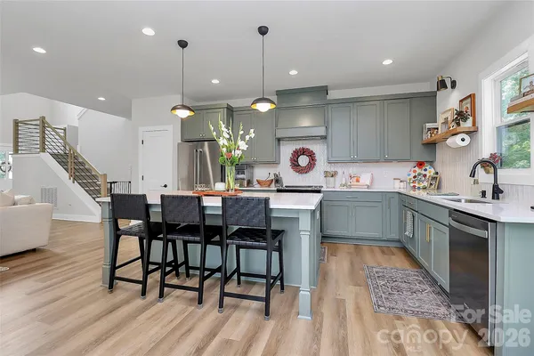 a kitchen with a table chairs sink and cabinets