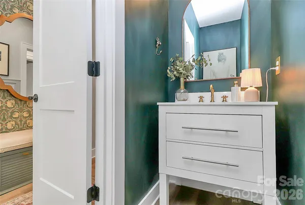 a bathroom with a sink vanity and mirror