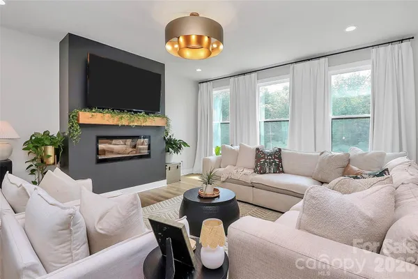 a living room with fireplace furniture and a flat screen tv