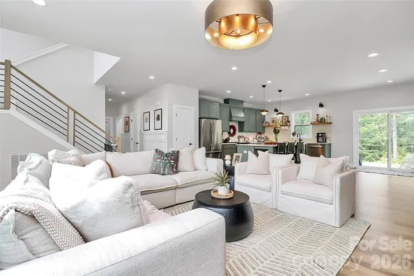 a living room with furniture and a wooden floor