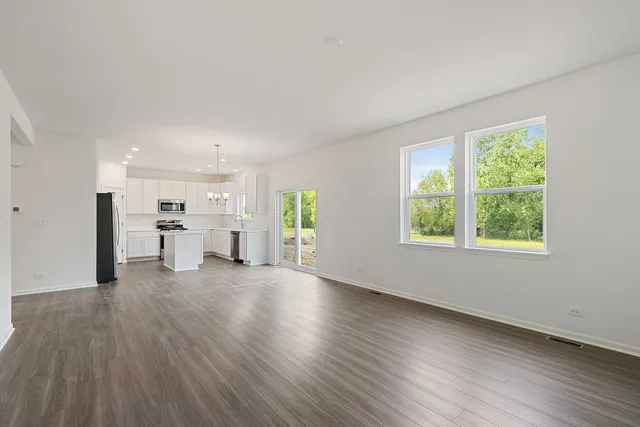 a view of a kitchen with furniture and wooden floor