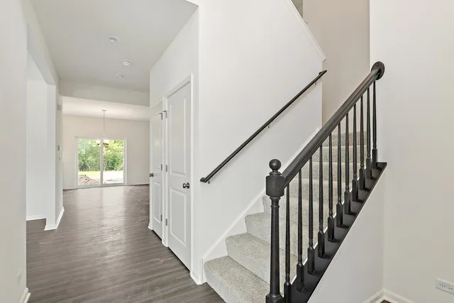 a view of an entryway with wooden floor