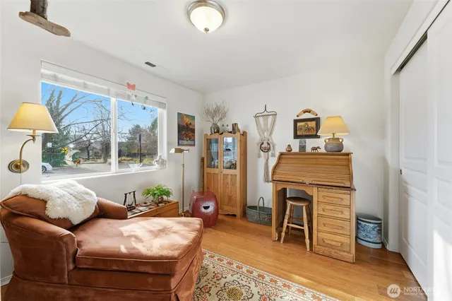 a living room with furniture a window and a flat screen tv