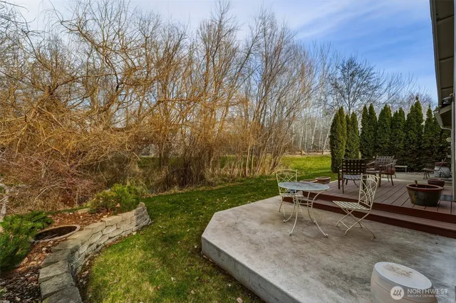 a view of a backyard with sitting area