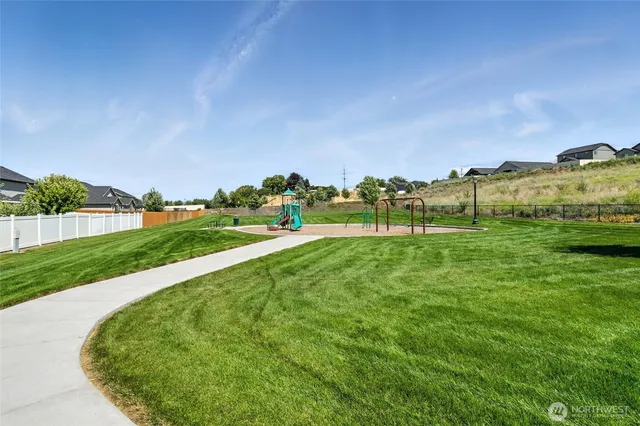 a view of grassy field with mountain
