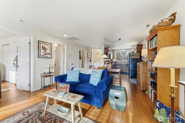 a living room with fireplace furniture and a wooden floor