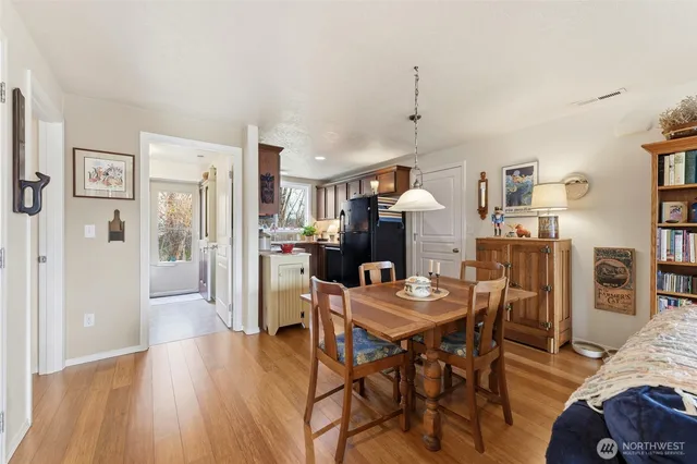 a dining room with furniture and wooden floor