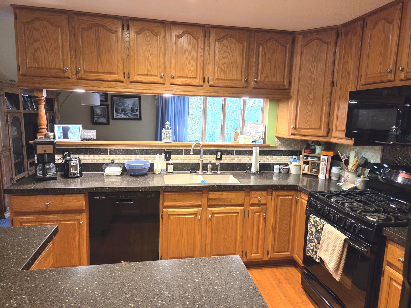 37322 Indian Spring Road Saybrook, IL 61770 - Photo 13 of 77 a kitchen with granite countertop wooden cabinets a sink and dishwasher