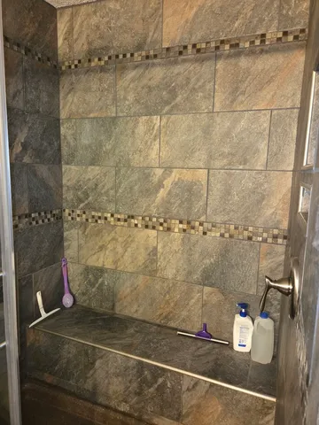 a view of a lake with a yard and large trees