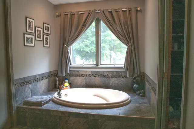 a view of a big house with a big yard and large trees