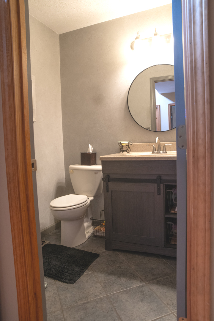 37322 Indian Spring Road Saybrook, IL 61770 - Photo 29 of 77 a bathroom with a toilet sink and mirror