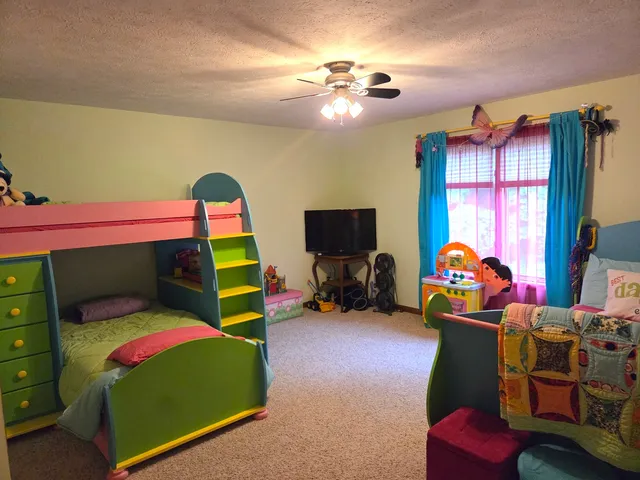 a view of a patio with chairs and potted plants on a wooden floor