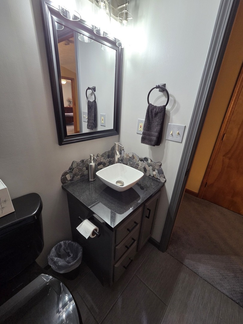 37322 Indian Spring Road Saybrook, IL 61770 - Photo 37 of 77 a bathroom with a granite countertop sink and a mirror with toilet