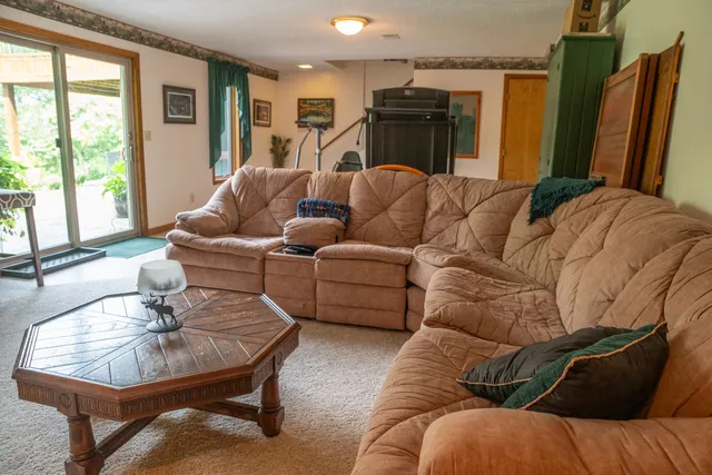 a view of a house with backyard and a tree