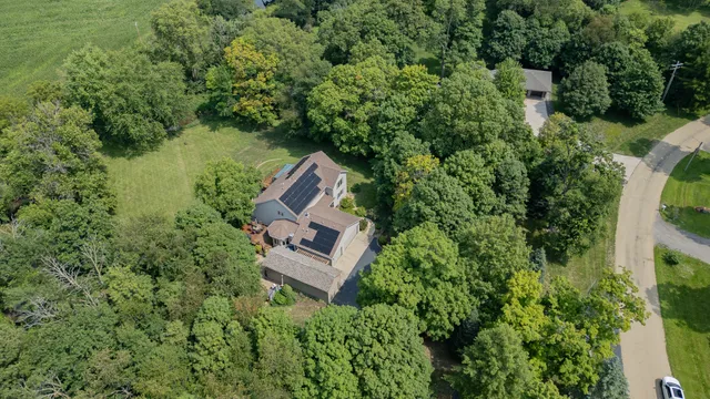 an aerial view of a house with outdoor space pool seating area and yard
