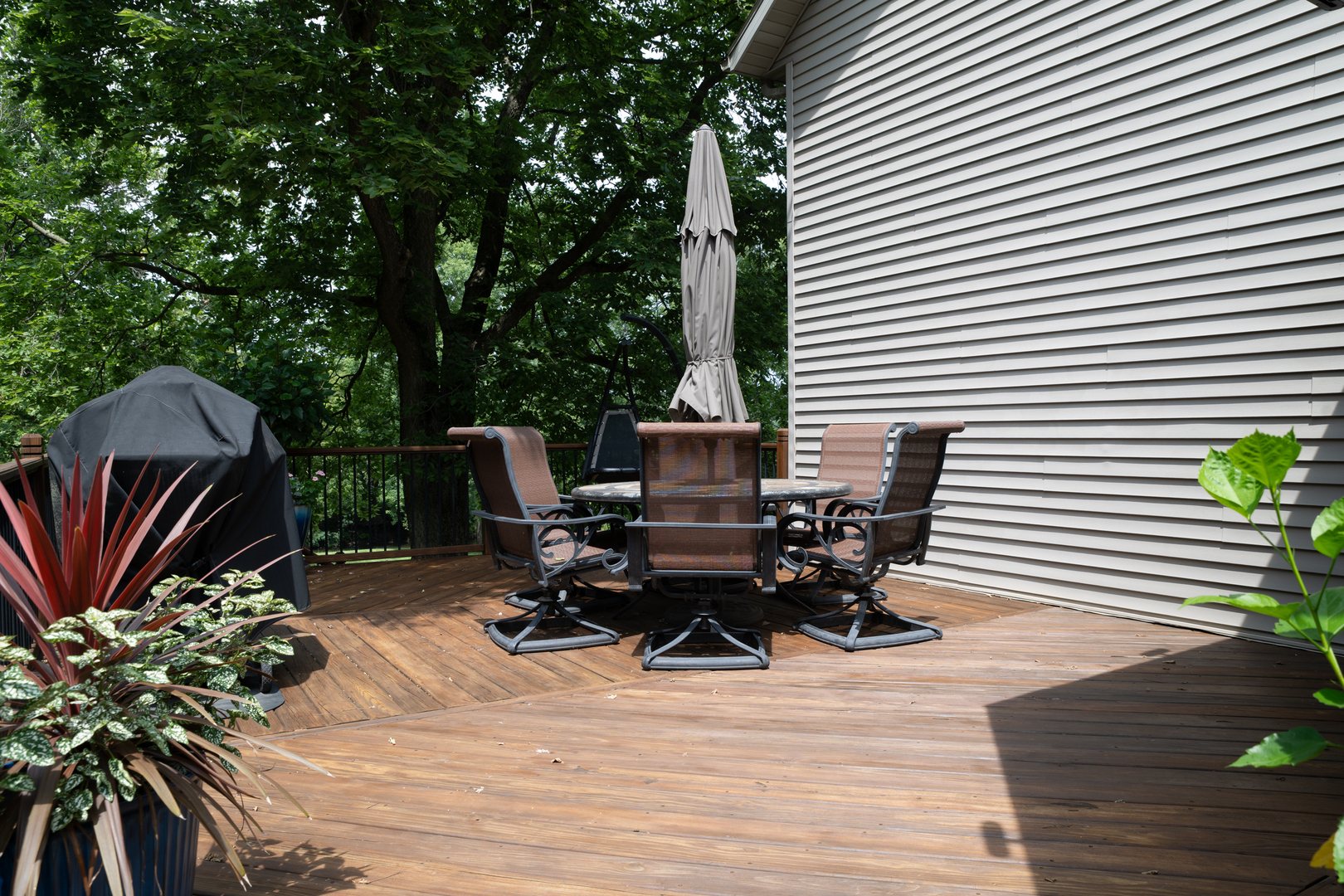 37322 Indian Spring Road Saybrook, IL 61770 - Photo 62 of 77 a view of a patio with chairs and potted plants on a wooden floor