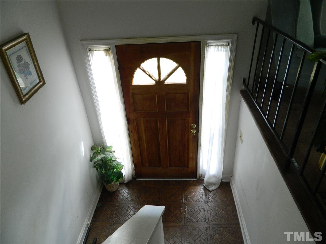 1104 Mockingbird Drive Raleigh, NC 27615 - Photo 4 of 10 wooden floor in an empty room with a window