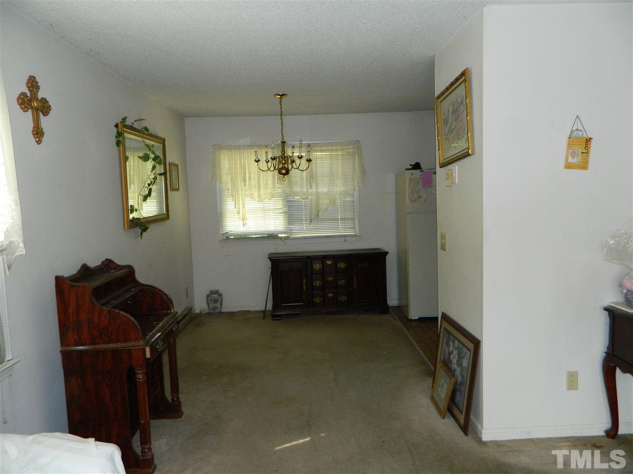 1104 Mockingbird Drive Raleigh, NC 27615 - Photo 6 of 10 a living room with furniture and a chandelier