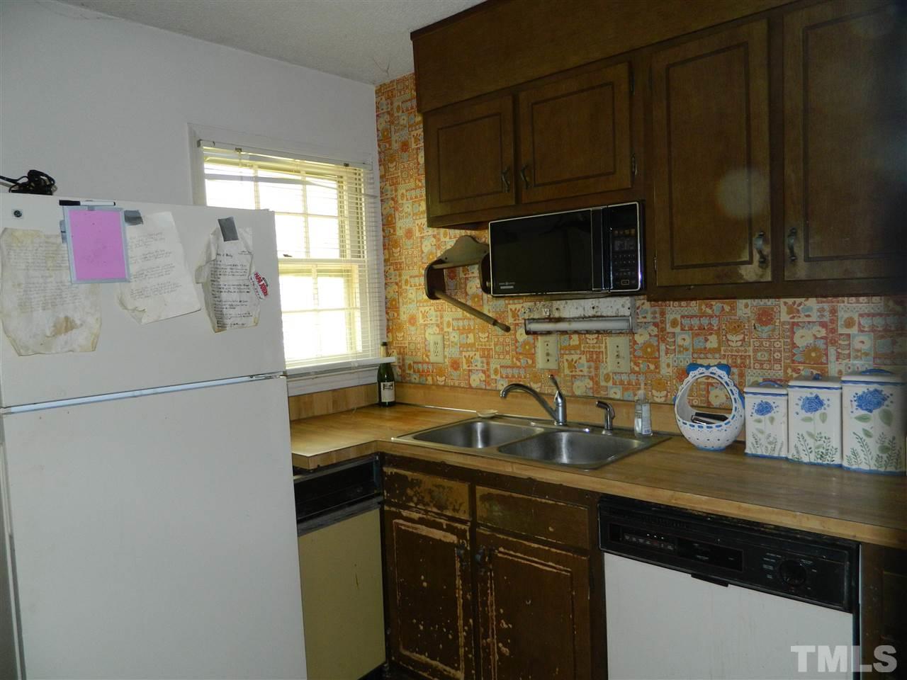 1104 Mockingbird Drive Raleigh, NC 27615 - Photo 8 of 10 a kitchen with a sink and a microwave