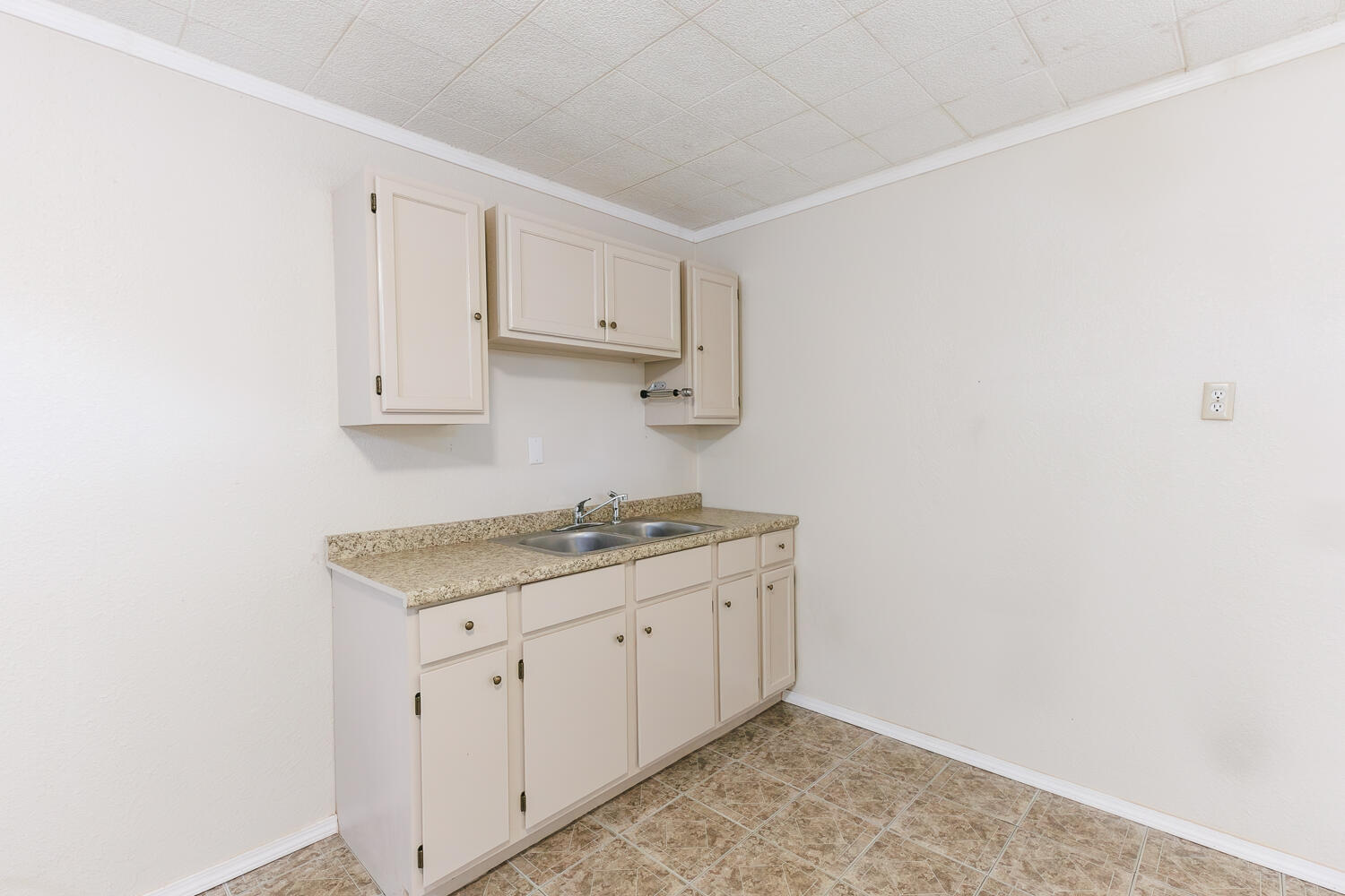 211 Chestnut Street Idalou, TX 79329 - Photo 15 of 31 a kitchen with white cabinets