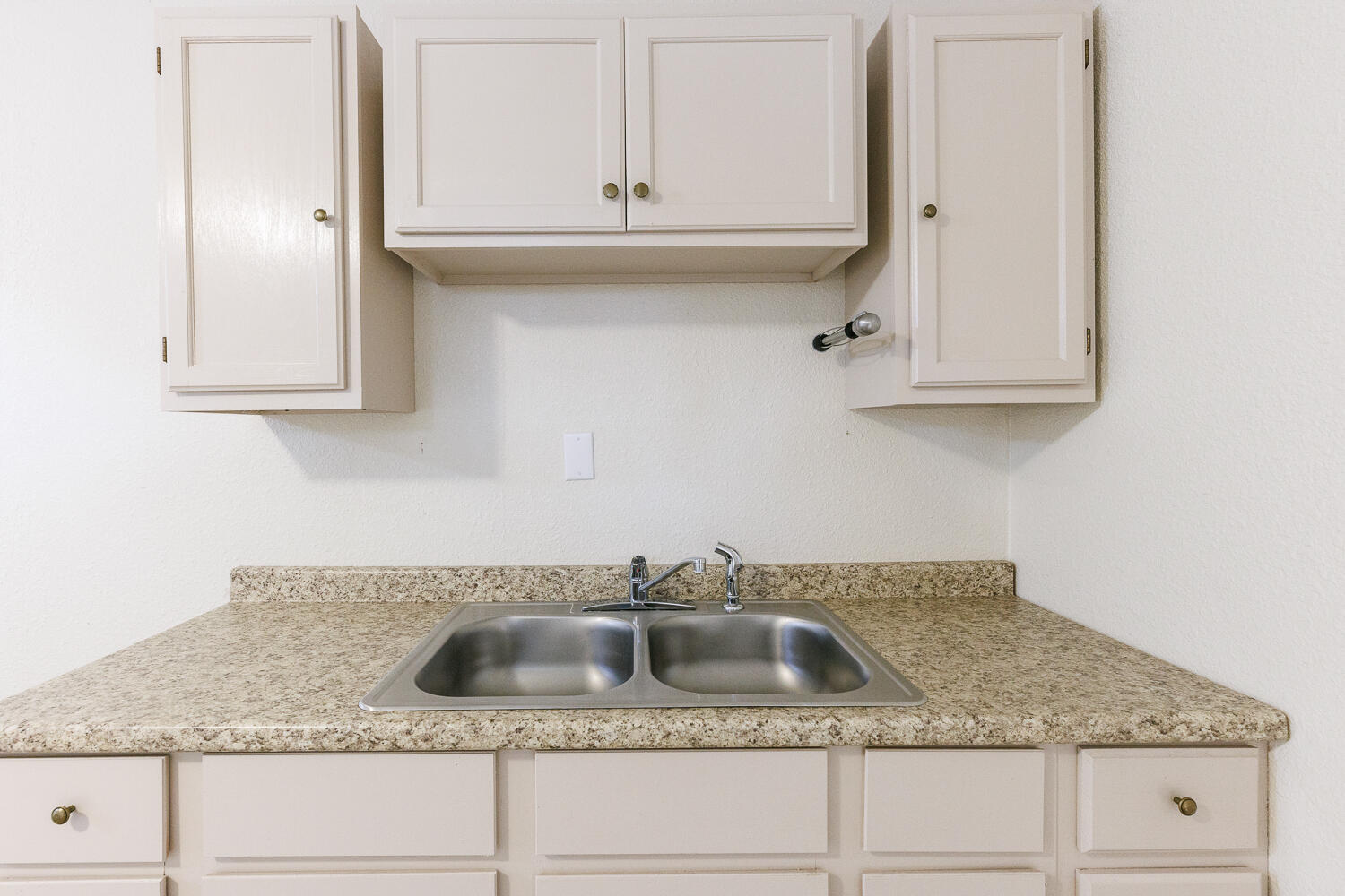 211 Chestnut Street Idalou, TX 79329 - Photo 16 of 31 a kitchen with granite countertop a sink and cabinets