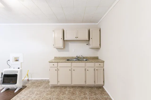 a kitchen with granite countertop a sink and a stove