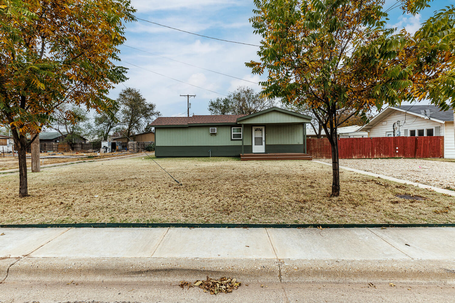 211 Chestnut Street Idalou, TX 79329 - Photo 2 of 31 a front view of a house with a yard