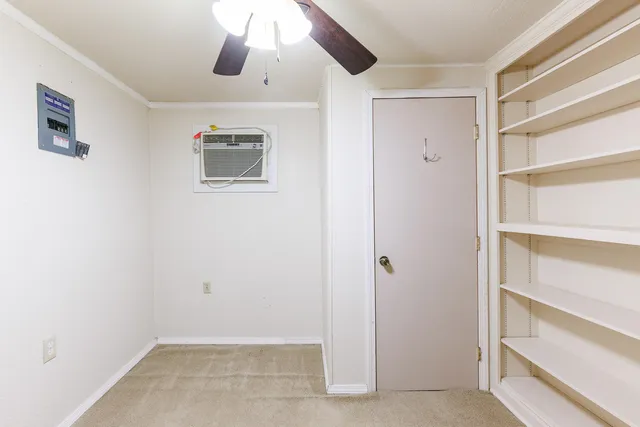 a view of a room with a ceiling fan