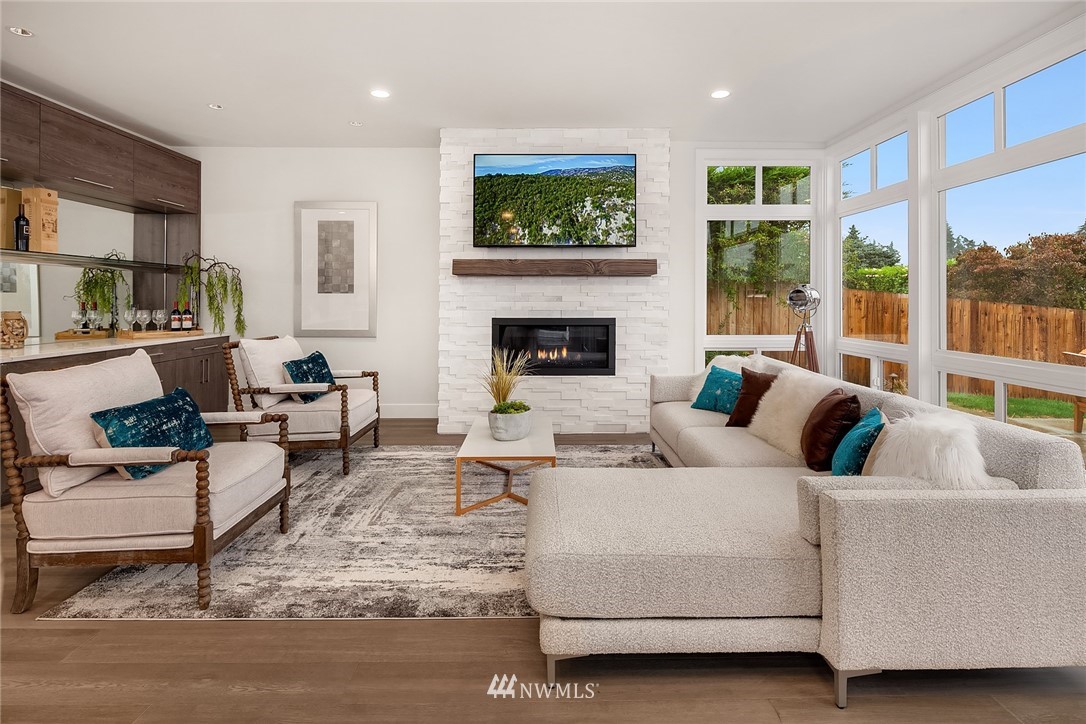 8431 Ridge Road Medina, WA 98039 - Photo 11 of 40 a living room with furniture large window and a fireplace