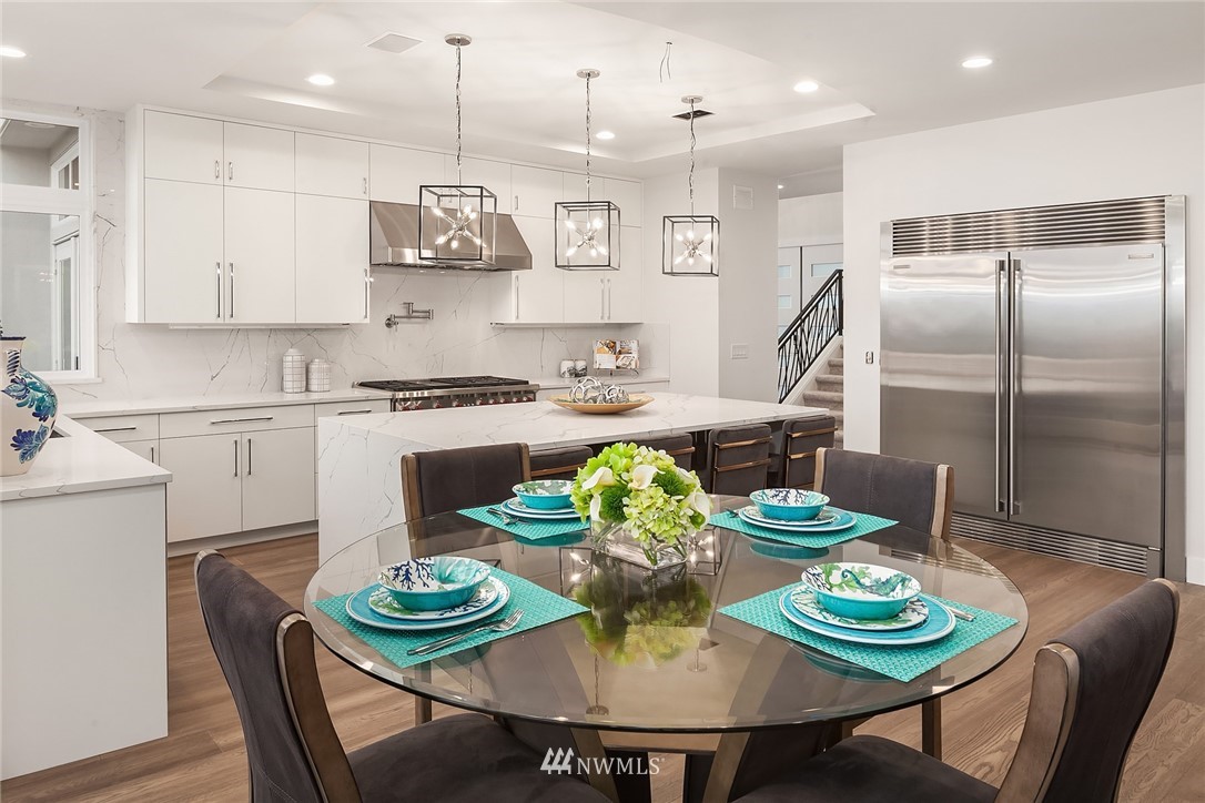 8431 Ridge Road Medina, WA 98039 - Photo 15 of 40 a kitchen with stainless steel appliances granite countertop a dining table and chairs