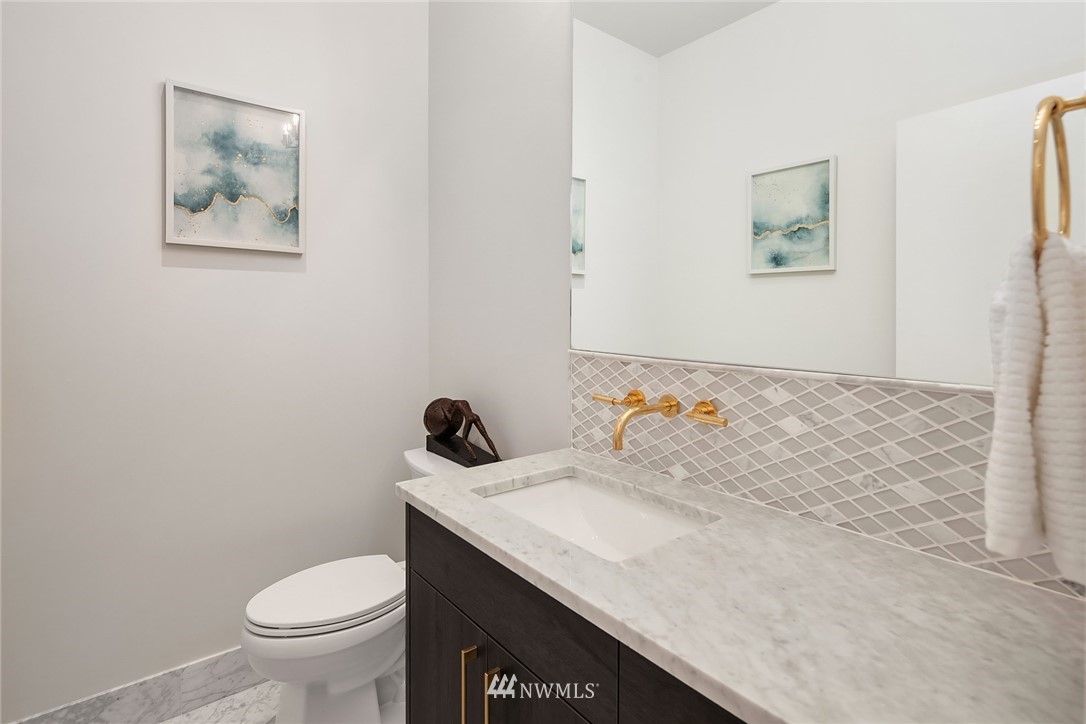 8431 Ridge Road Medina, WA 98039 - Photo 19 of 40 a bathroom with a granite countertop sink and a toilet