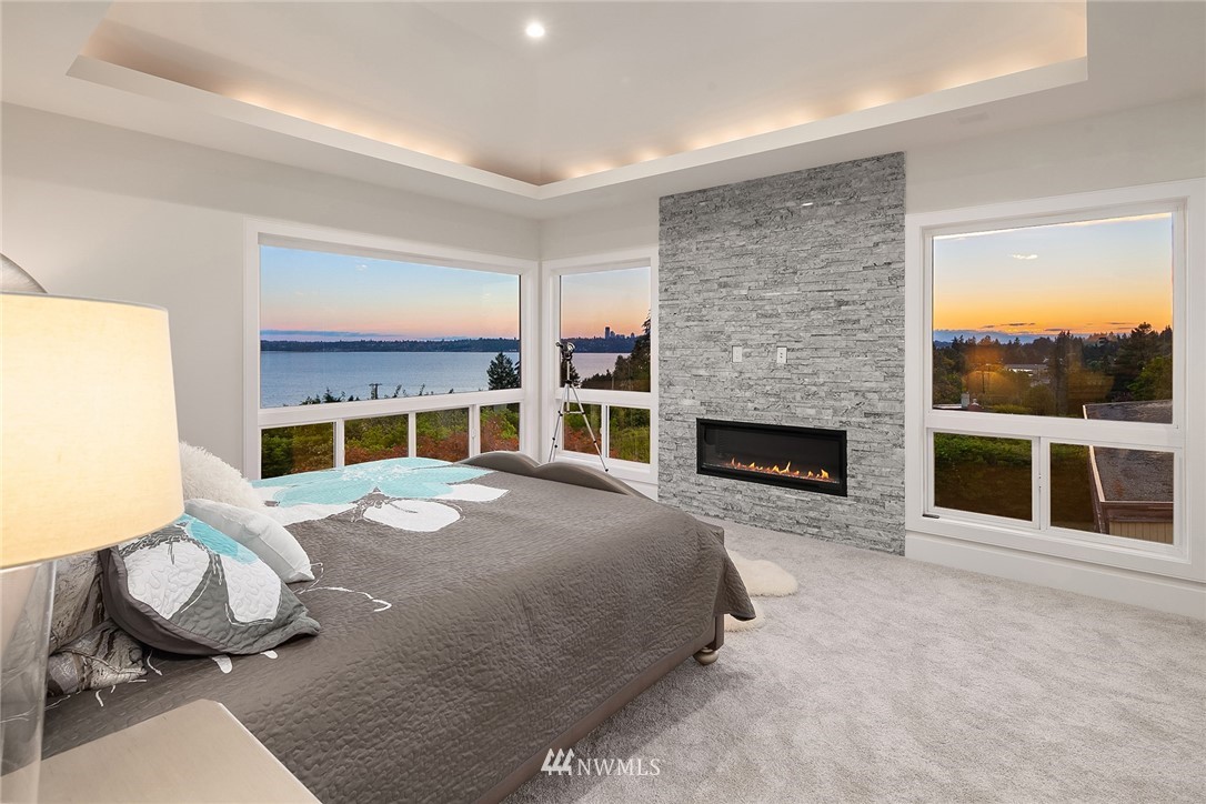 8431 Ridge Road Medina, WA 98039 - Photo 24 of 40 a bed room with a fireplace and window