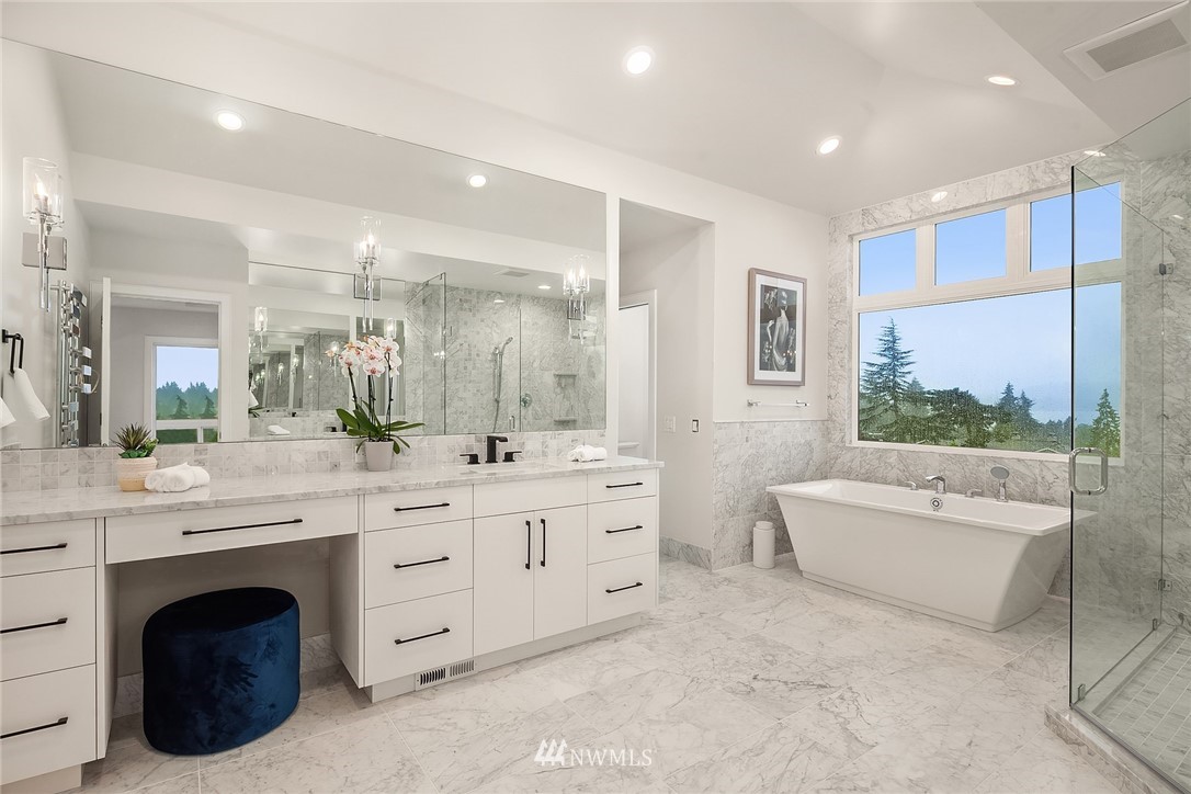 8431 Ridge Road Medina, WA 98039 - Photo 25 of 40 a large bathroom with a double vanity sink a large mirror and a bathtub