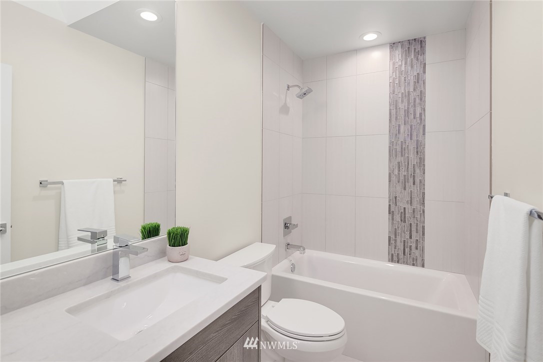 8431 Ridge Road Medina, WA 98039 - Photo 28 of 40 a bathroom with a granite countertop bathtub shower sink vanity mirror and toilet