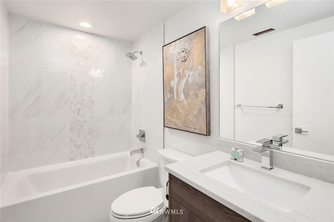 8431 Ridge Road Medina, WA 98039 - Photo 32 of 40 a bathroom with a granite countertop sink a toilet and shower