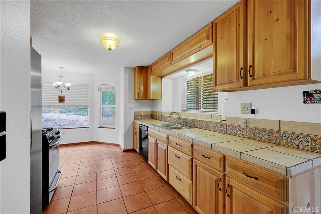 13233 Dixon Hill Road Oregon House, CA 95962 - Photo 17 of 60 a kitchen with a sink stove and cabinets