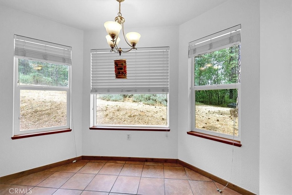 13233 Dixon Hill Road Oregon House, CA 95962 - Photo 20 of 60 a view of an empty room with wooden floor and windows