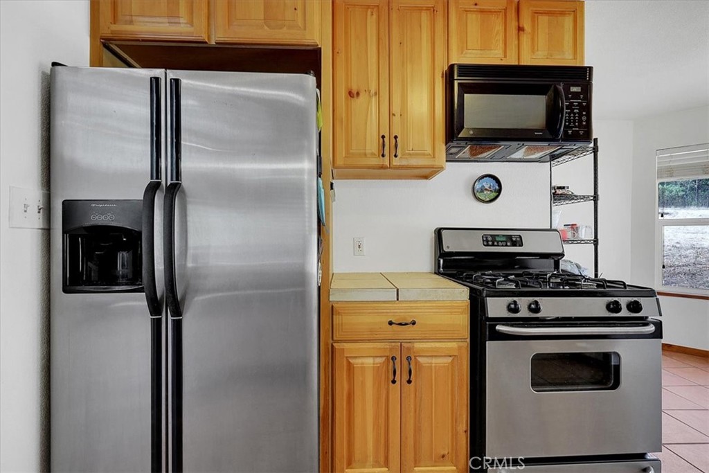 13233 Dixon Hill Road Oregon House, CA 95962 - Photo 23 of 60 a kitchen with a stove and a microwave
