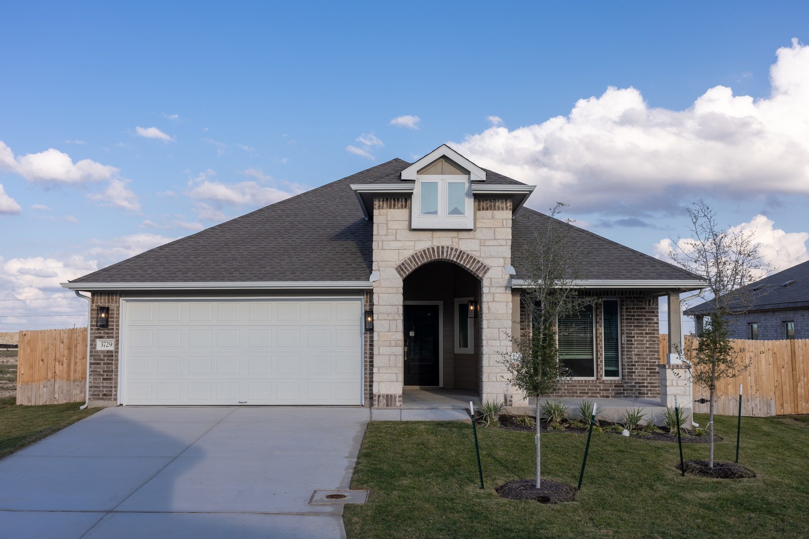 3729 Pin Oak Hills Seguin, TX 78155 - Photo 1 of 22 French country inspired facade with a shingled roof, concrete driveway, brick siding, and stone siding