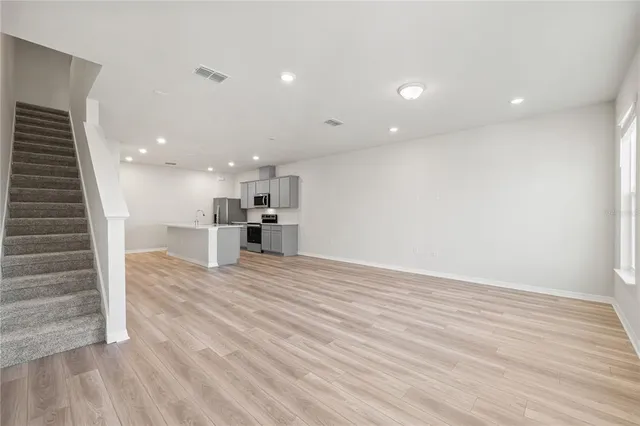 a view of kitchen and hall with wooden floor