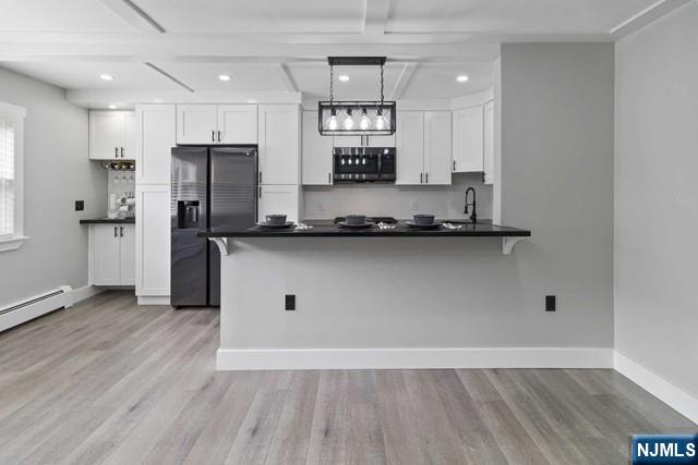 a view of a kitchen with electric appliances