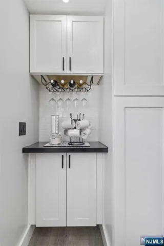 a kitchen with a sink a microwave and cabinets