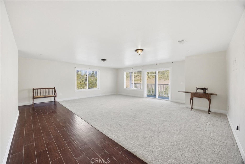 9401 Whispering Pines Road Frazier Park, CA 93225 - Photo 36 of 49 a view of a livingroom with wooden floor and a workspace