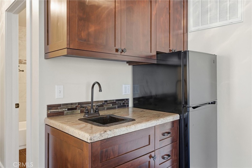 9401 Whispering Pines Road Frazier Park, CA 93225 - Photo 39 of 49 a kitchen with granite countertop white cabinets and a sink