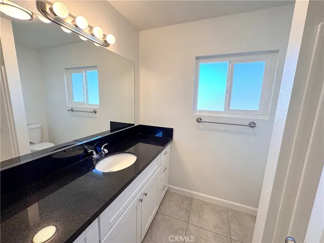 a bathroom with a sink vanity and a mirror