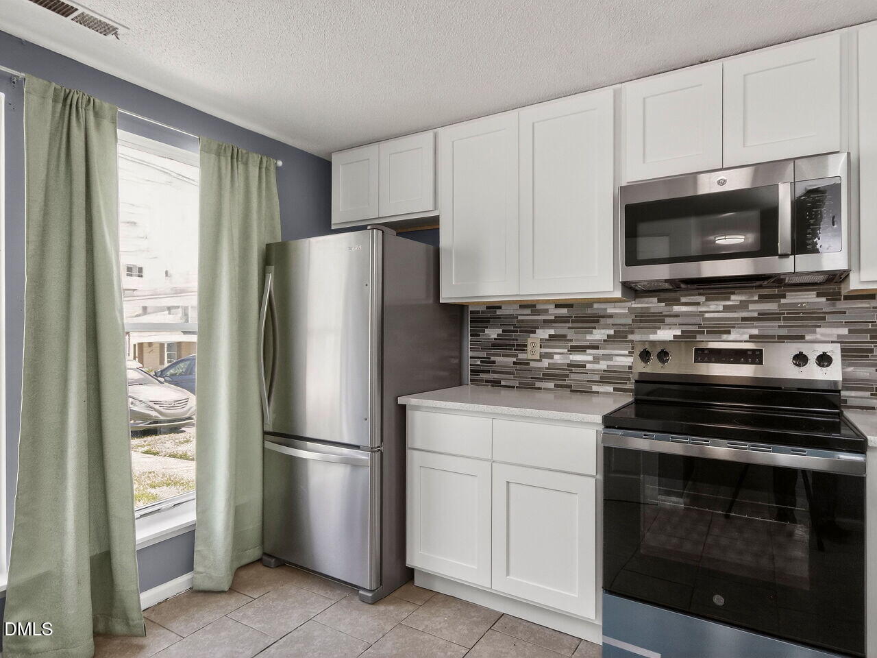 4333 Halliwell Drive Raleigh, NC 27606 - Photo 3 of 31 a kitchen with cabinets stainless steel appliances and a window