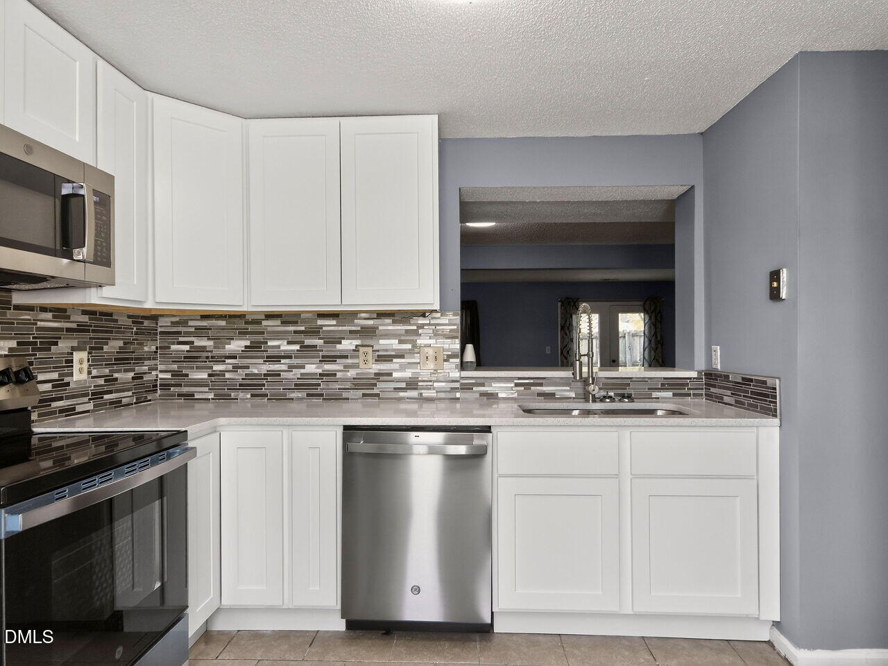 4333 Halliwell Drive Raleigh, NC 27606 - Photo 4 of 31 a kitchen with stainless steel appliances granite countertop a stove and a sink