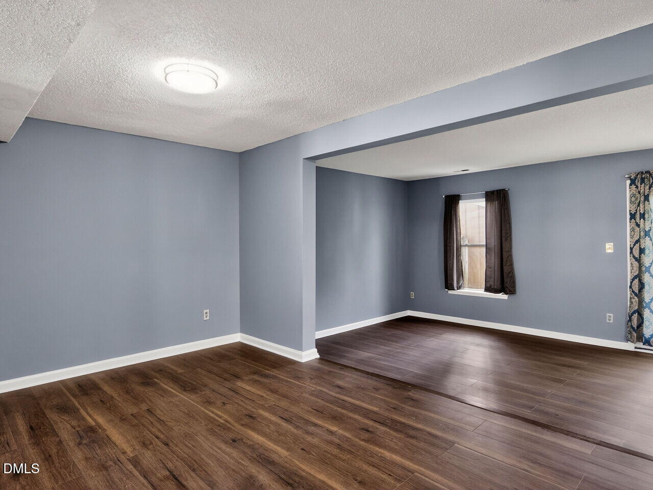 4333 Halliwell Drive Raleigh, NC 27606 - Photo 5 of 31 a view of an empty room with wooden floor and a window