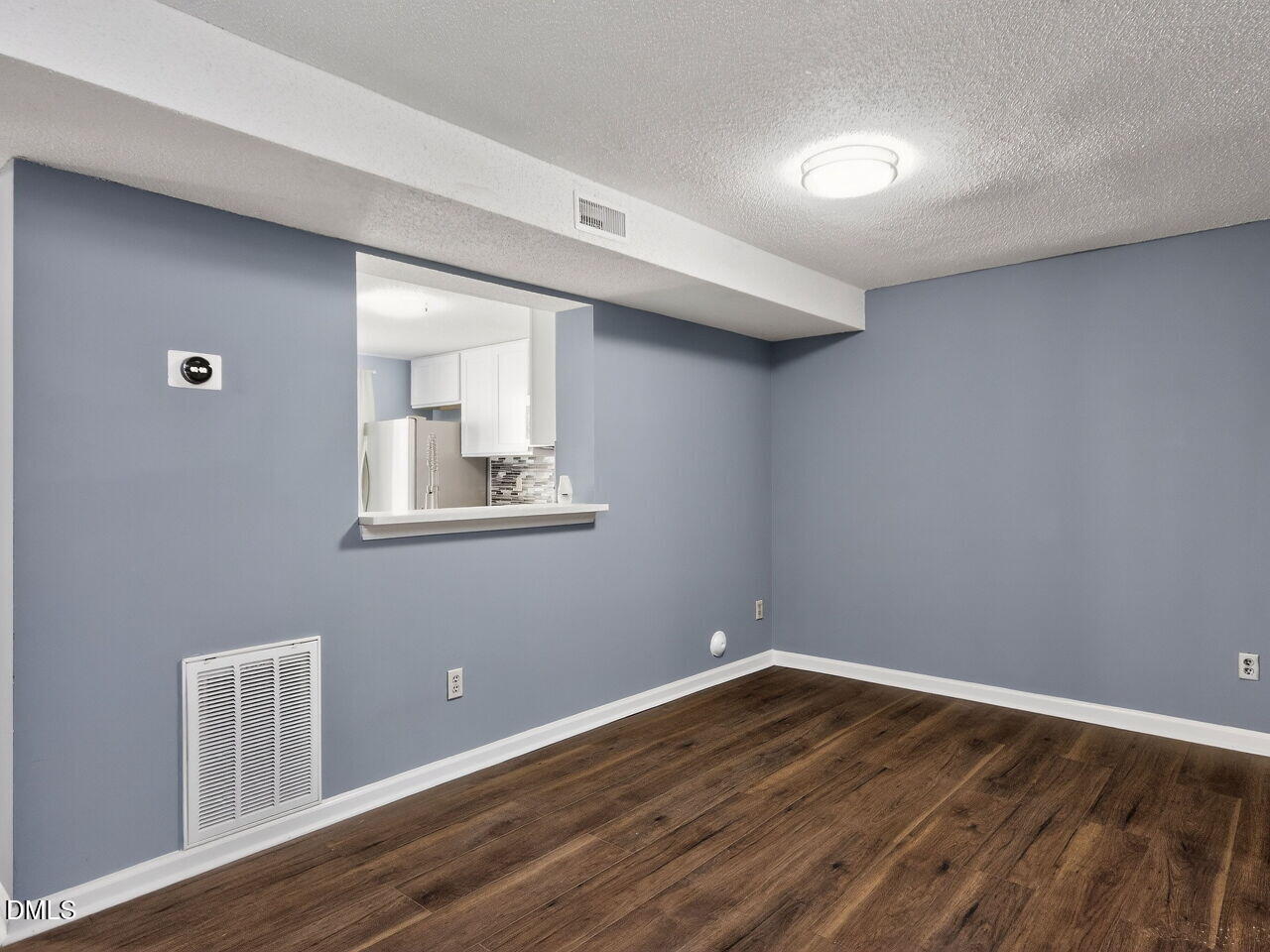 4333 Halliwell Drive Raleigh, NC 27606 - Photo 6 of 31 a room with wooden floor and white walls