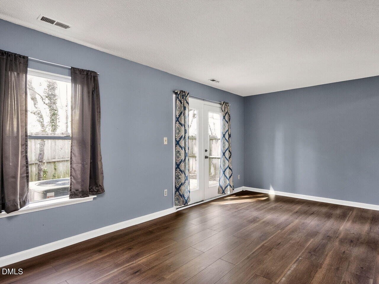 4333 Halliwell Drive Raleigh, NC 27606 - Photo 8 of 31 a view of an empty room with wooden floor and a window